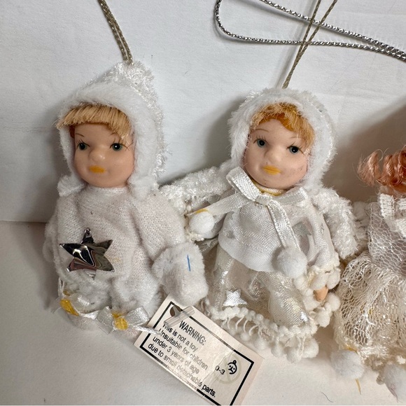 NWT. 7 porcelain doll ornaments. 5 of little girl and 2 of baby. - Picture 2 of 14
